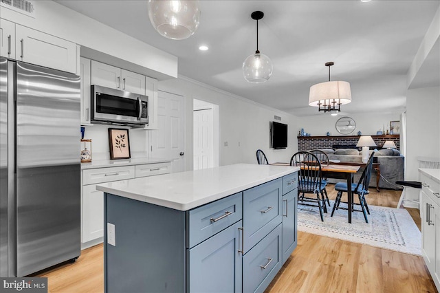 kitchen featuring light wood-type flooring, visible vents, appliances with stainless steel finishes, and white cabinetry