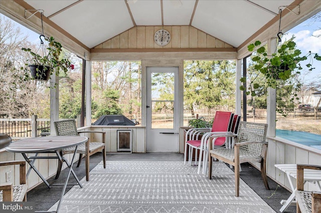 sunroom featuring lofted ceiling