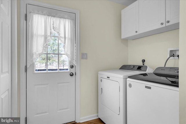 laundry room with cabinet space, baseboards, and separate washer and dryer