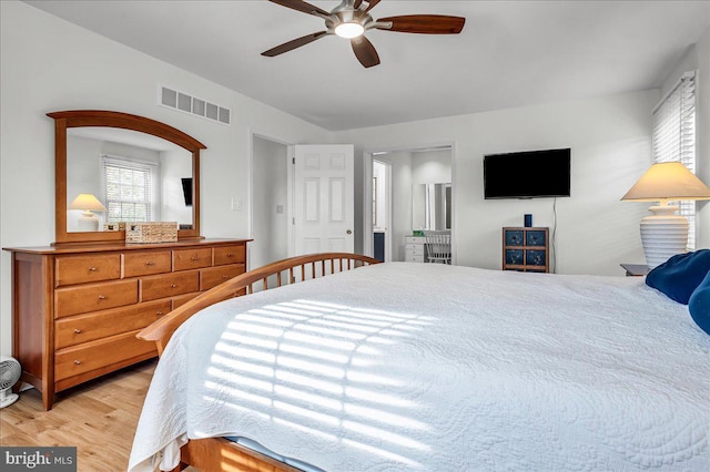 bedroom featuring visible vents, light wood-style floors, and a ceiling fan