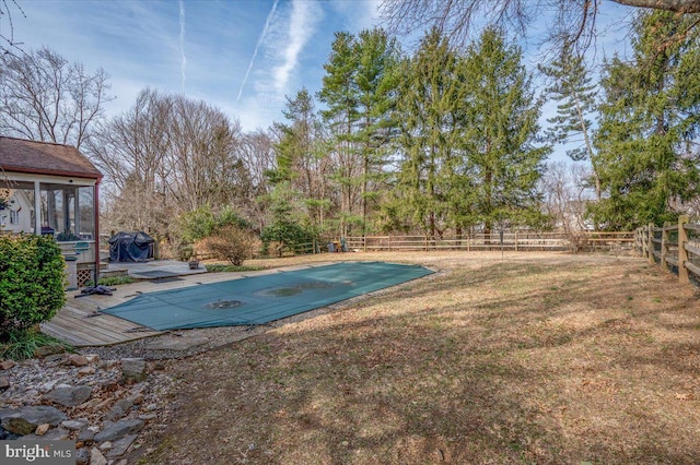 view of swimming pool with grilling area, a fenced in pool, a sunroom, a yard, and a fenced backyard