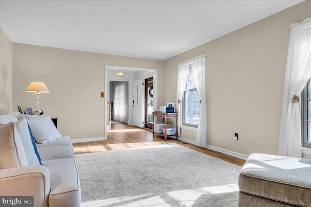 living room featuring light wood-style flooring and baseboards