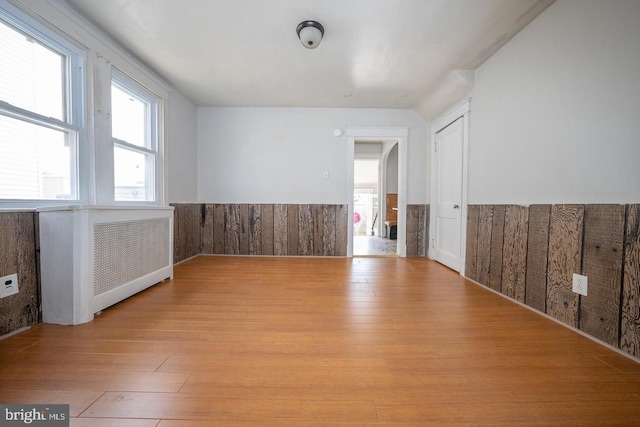 empty room with a wainscoted wall and light wood-style floors