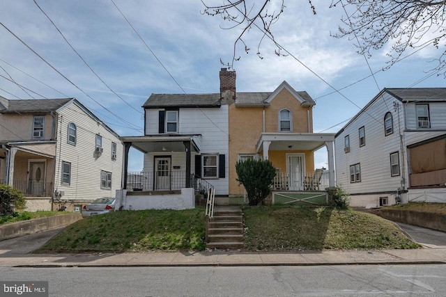 view of front of house with covered porch and a chimney