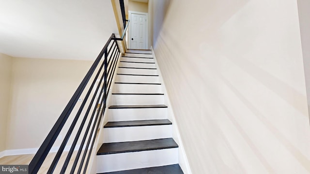 stairs featuring baseboards and wood finished floors