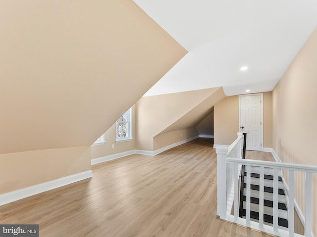 bonus room featuring recessed lighting, light wood-style flooring, baseboards, and vaulted ceiling