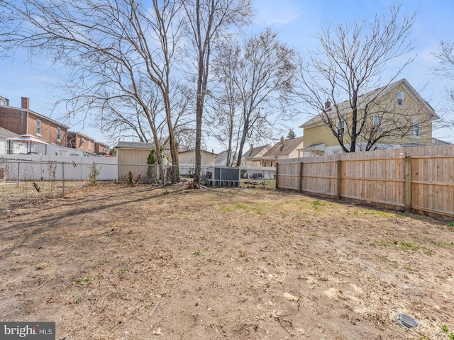 view of yard featuring a residential view and a fenced backyard