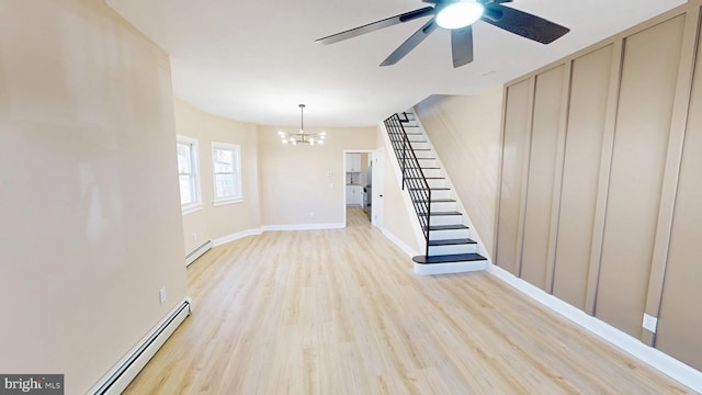 unfurnished living room with light wood finished floors, stairway, ceiling fan with notable chandelier, and a baseboard radiator