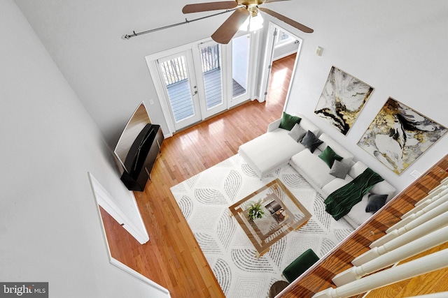 living room with wood finished floors, french doors, and ceiling fan