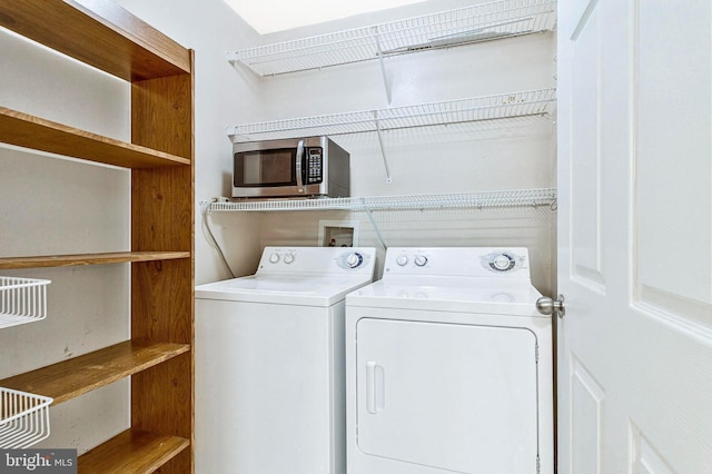 washroom featuring laundry area and washer and clothes dryer