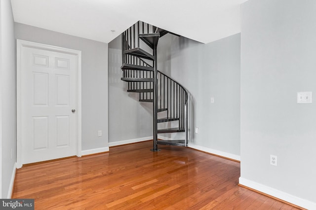 stairway with baseboards and wood finished floors