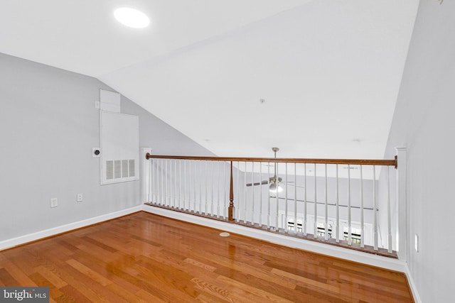 interior space featuring baseboards, lofted ceiling, and wood finished floors