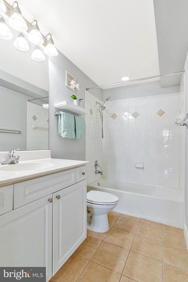 bathroom with toilet, a textured ceiling, tile patterned flooring, bathtub / shower combination, and vanity