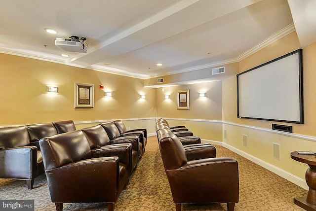 home theater room with visible vents, baseboards, carpet, and ornamental molding