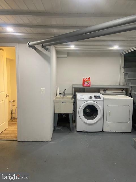 laundry room with laundry area, washer and dryer, and a sink