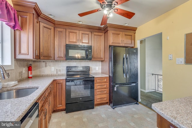 kitchen featuring black appliances, brown cabinetry, tasteful backsplash, and a sink