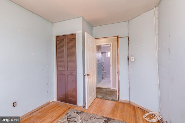 bedroom with a closet and light wood-style floors