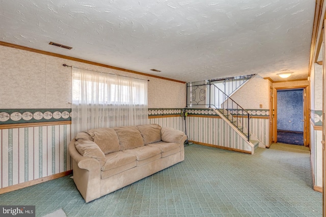 carpeted living area with a textured ceiling, wallpapered walls, and crown molding