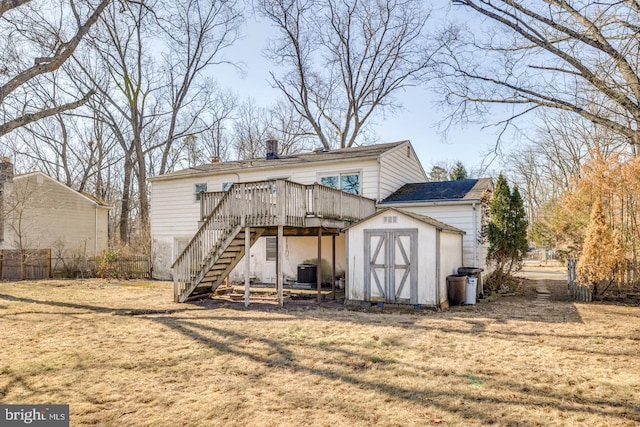 view of shed featuring stairs, cooling unit, and fence