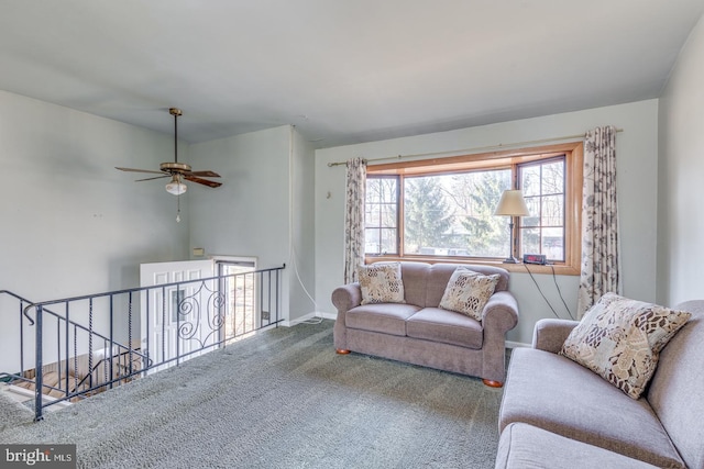 carpeted living area featuring baseboards