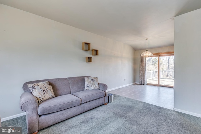 living area featuring carpet flooring and baseboards