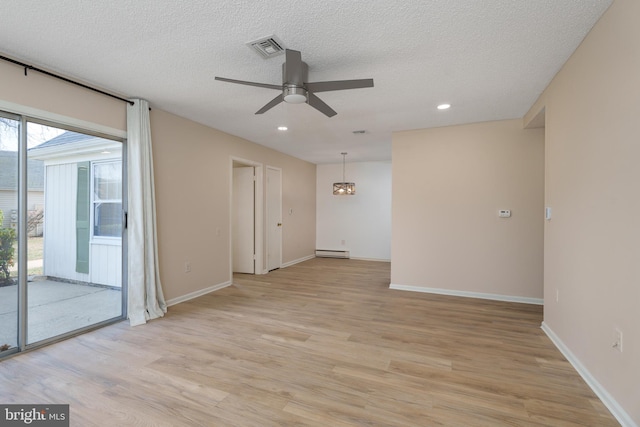 empty room with visible vents, a ceiling fan, light wood-style floors, and a baseboard radiator