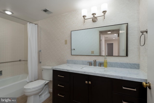 full bath featuring visible vents, toilet, tile walls, shower / tub combo, and vanity