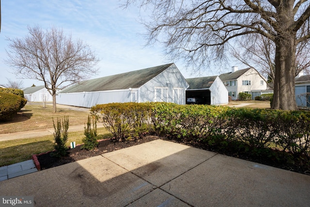 view of patio / terrace with an outbuilding and an attached carport