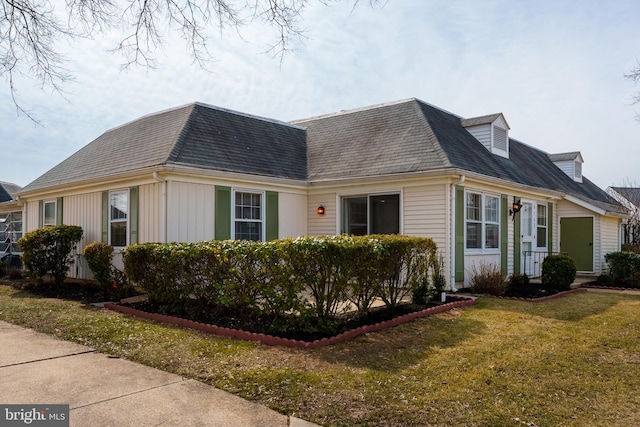 view of side of home with a yard