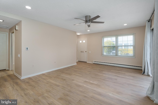 unfurnished room featuring baseboards, a baseboard radiator, light wood-style flooring, recessed lighting, and a textured ceiling