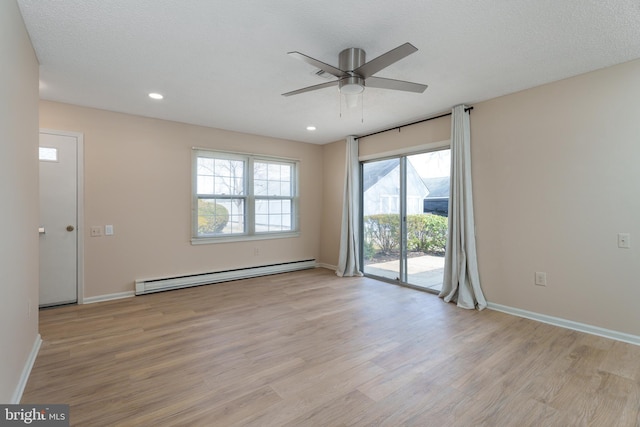 unfurnished room with recessed lighting, baseboards, baseboard heating, and light wood-style flooring