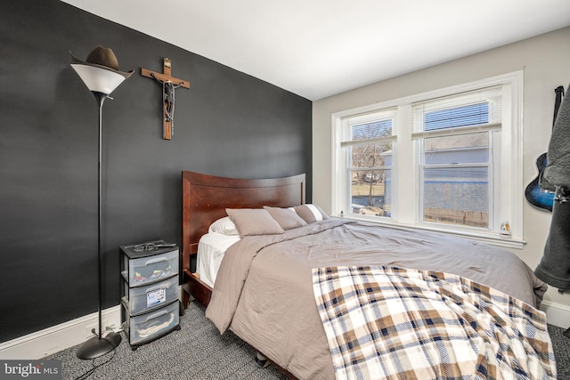 bedroom featuring carpet flooring and baseboards