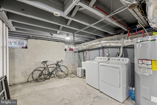 basement featuring washer and dryer and electric water heater