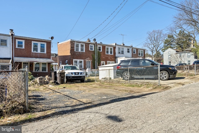 townhome / multi-family property featuring fence and brick siding