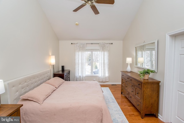 bedroom featuring light wood-style flooring, high vaulted ceiling, baseboards, and ceiling fan