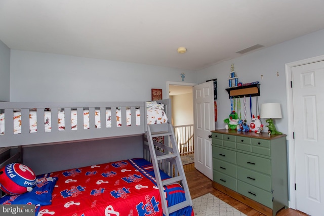 bedroom with visible vents and wood finished floors