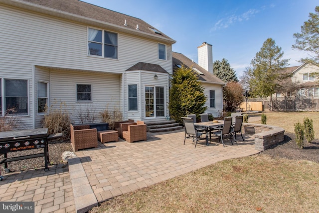 rear view of house featuring a patio, fence, roof with shingles, a chimney, and entry steps