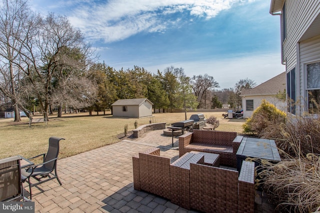 view of patio / terrace featuring an outdoor structure, area for grilling, and an outdoor hangout area