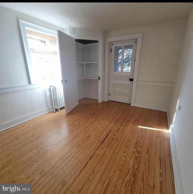 interior space with radiator and light wood-style floors