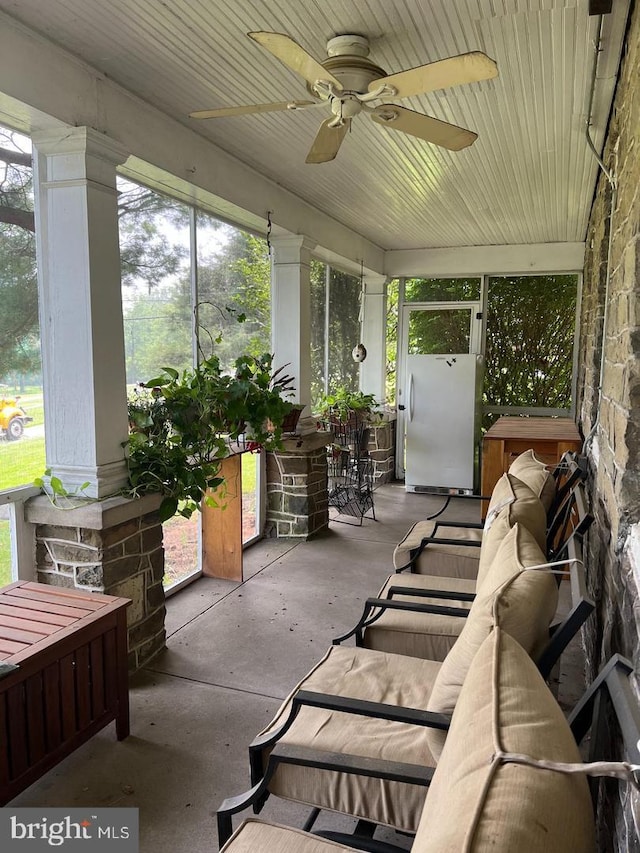 sunroom with plenty of natural light and ceiling fan