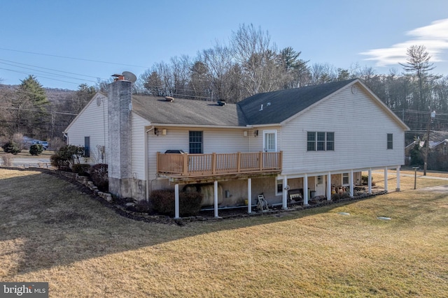 back of property featuring a lawn, a chimney, and a deck