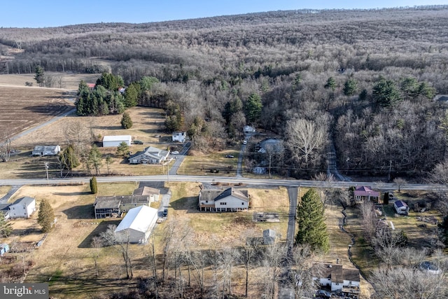 drone / aerial view featuring a forest view