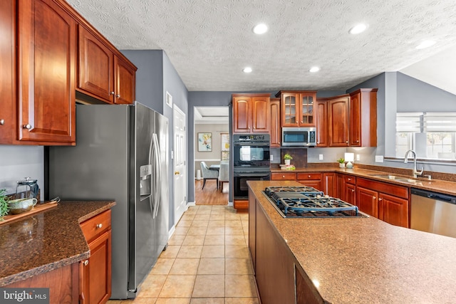 kitchen featuring black appliances, a sink, recessed lighting, light tile patterned floors, and glass insert cabinets