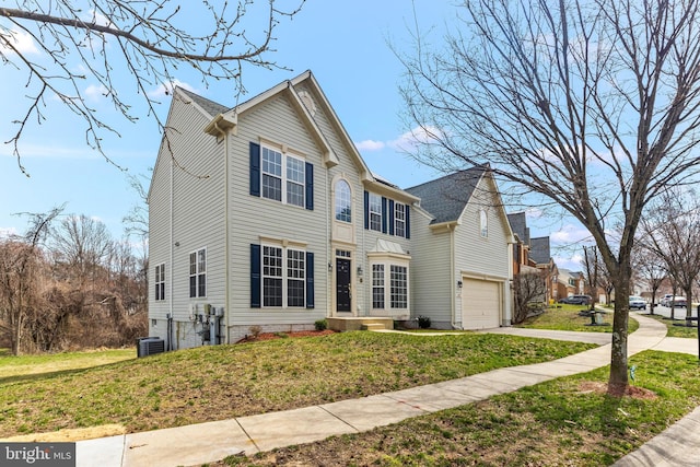 traditional-style home with cooling unit, a front yard, concrete driveway, and an attached garage