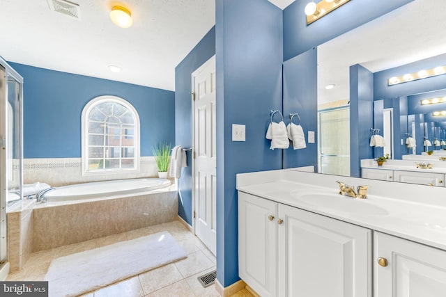 full bath featuring tile patterned floors, visible vents, a garden tub, and a shower stall
