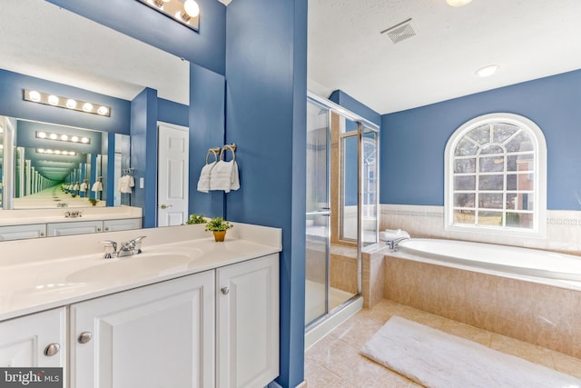 full bathroom with visible vents, a stall shower, tile patterned flooring, a bath, and vanity