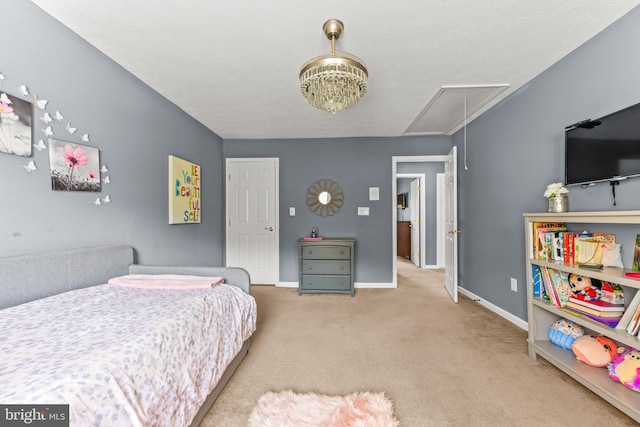bedroom featuring carpet flooring, attic access, and baseboards