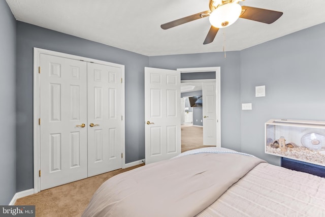 bedroom with baseboards, a closet, carpet floors, and ceiling fan