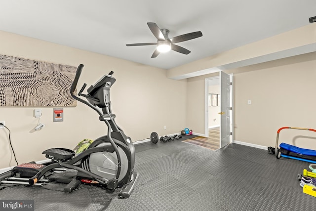 workout room with a ceiling fan and baseboards