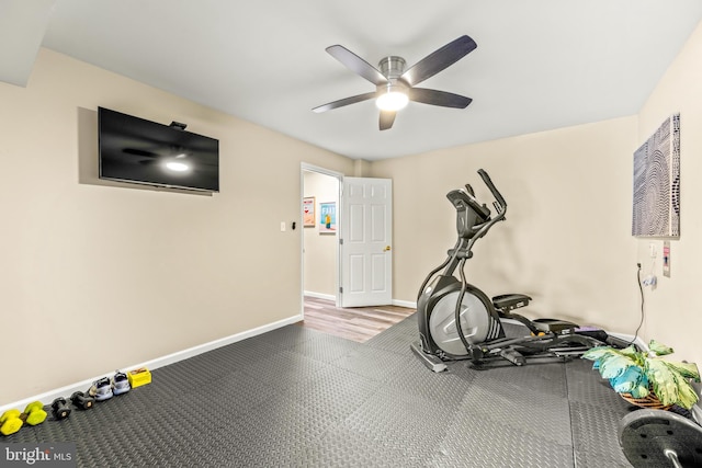 workout area featuring baseboards and ceiling fan